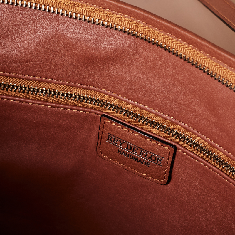 Tan handcrafted full grain leather tote bag with YKK zipper and internal leather lining.