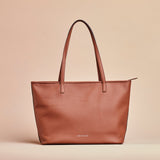 Tan handcrafted full grain leather tote bag with YKK zipper and internal leather lining.